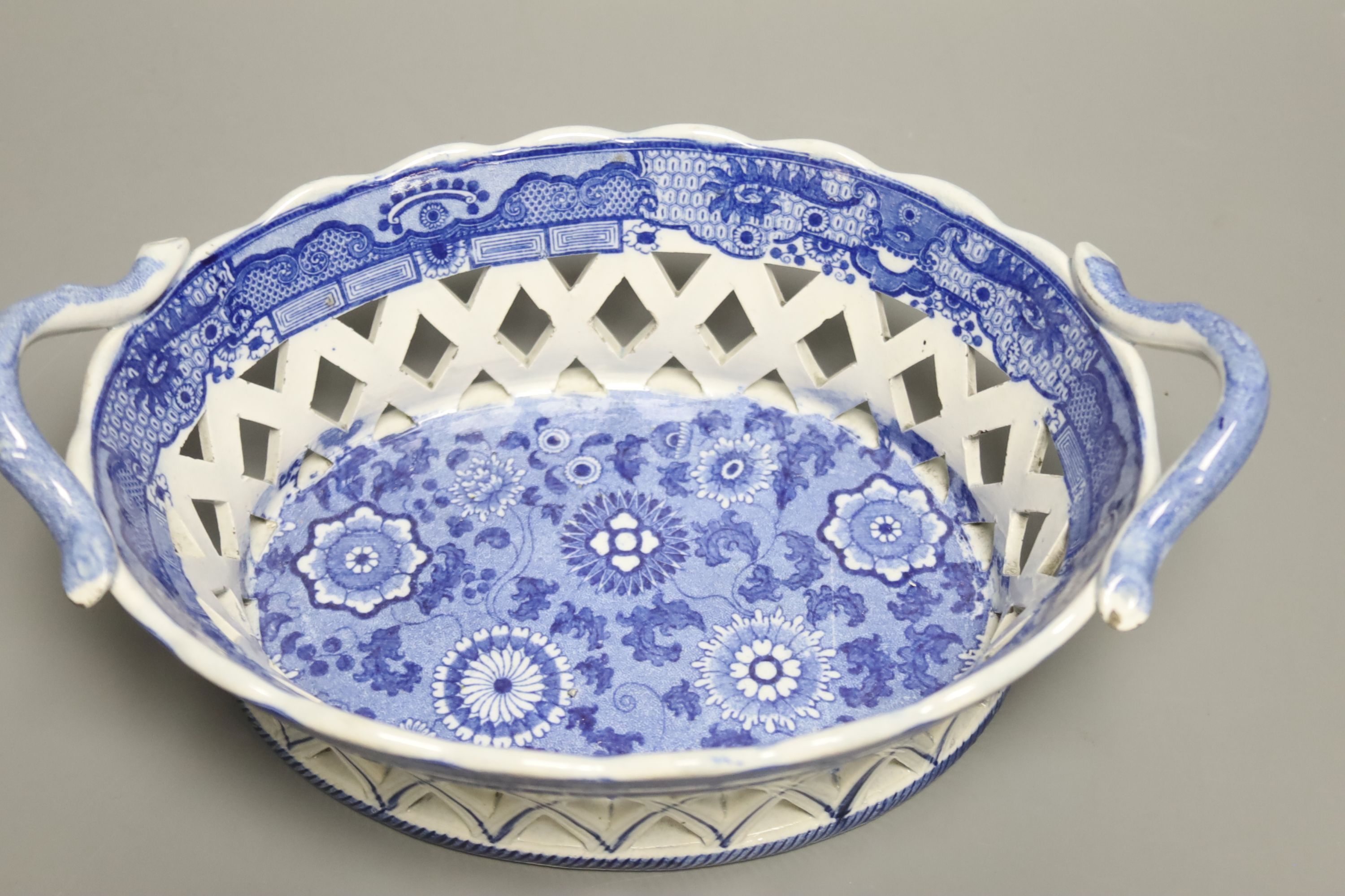An English pottery basket printed in under glaze blue with stylised motifs probably Spode, length 23.5cm
